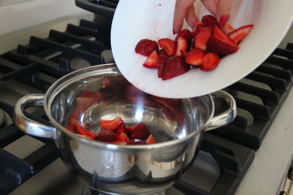 Put the strawberries in a saucepan together with water