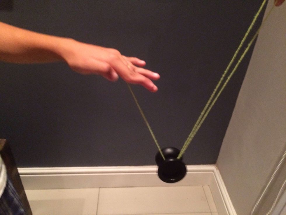 Put the string behind the yoyo,under the yoyo and then pull it away from you