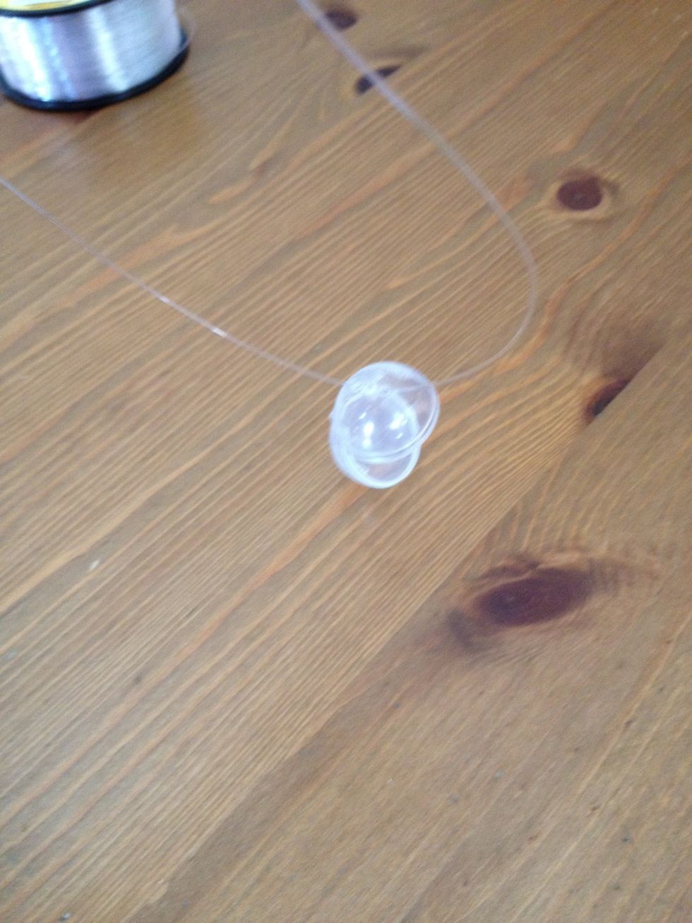 Put the string through the holes on ur Squinkie ball.