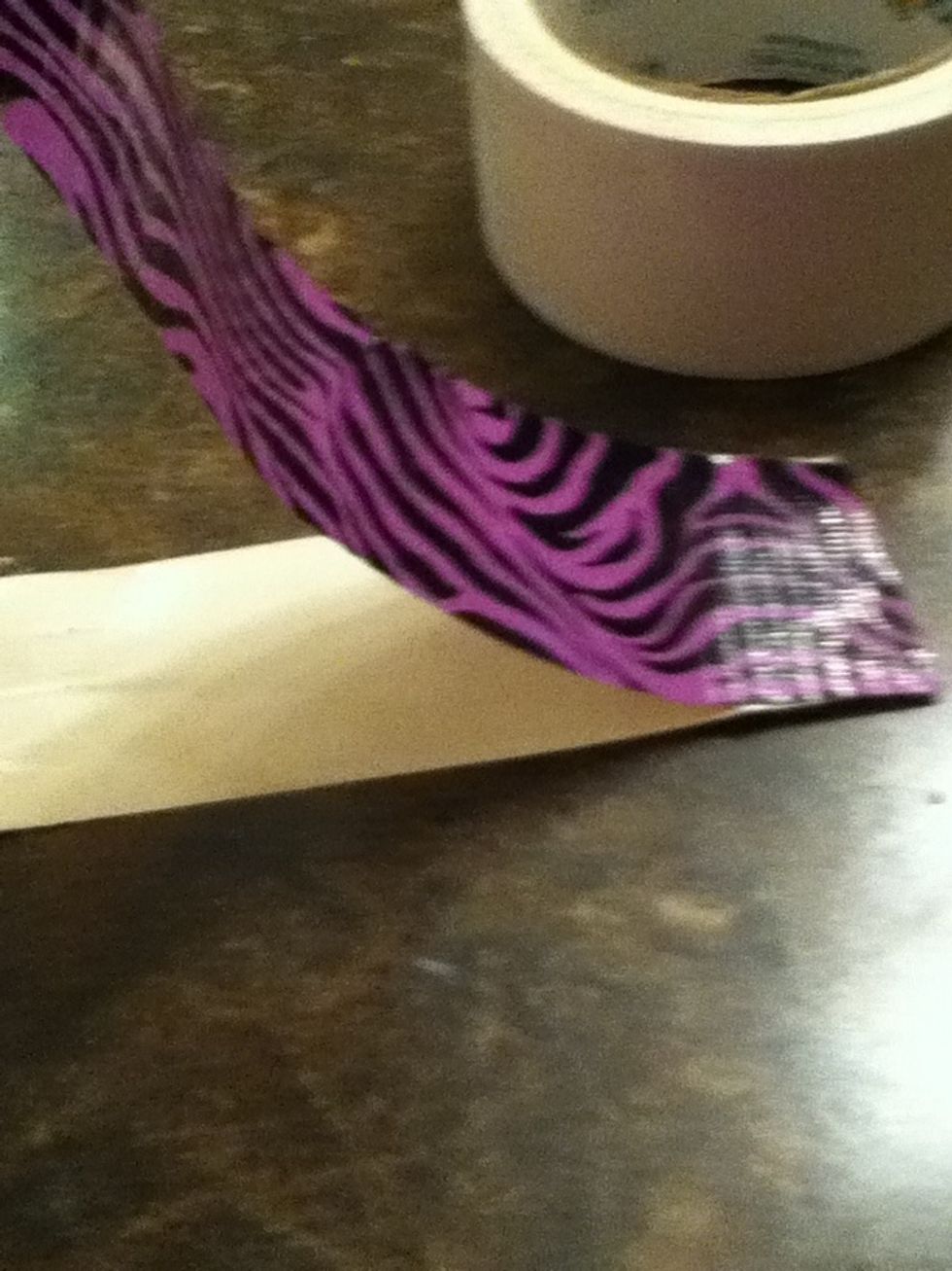 Put the strip of duct tape on the other strip Make sho its even or its gonna look ratchet