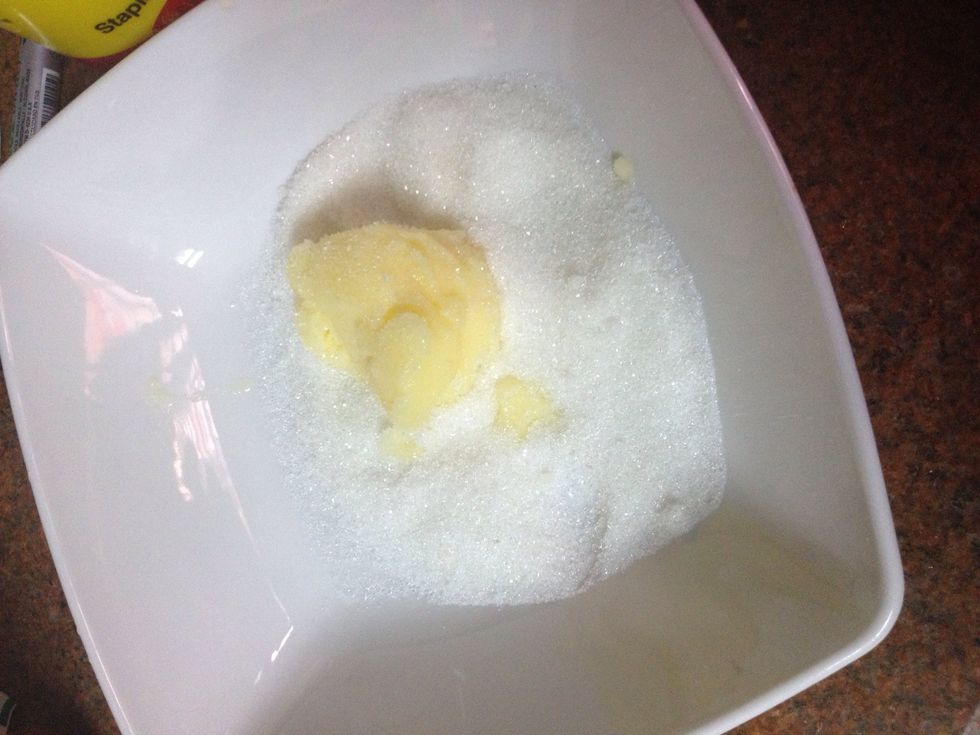 Put the sugar and the butter in a bowl and mix them well with your hands