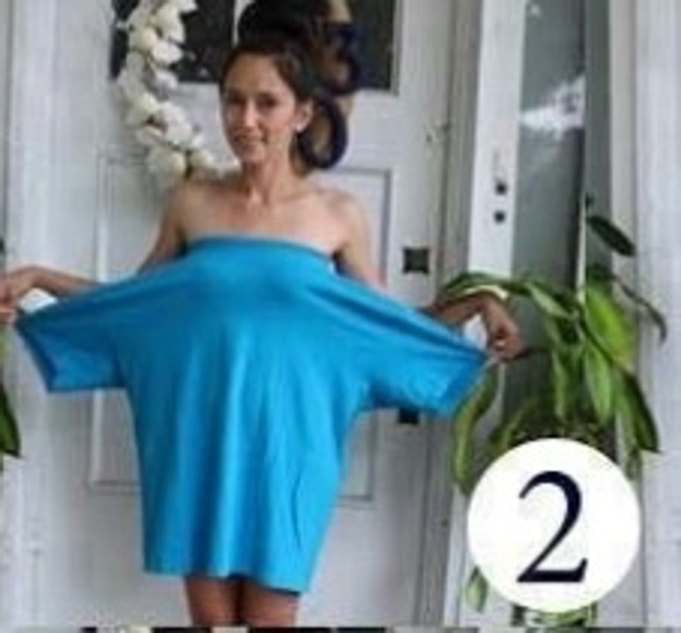 Put the t shirt on by putting your body in the neck hole with the sleeves hanging to the sides.