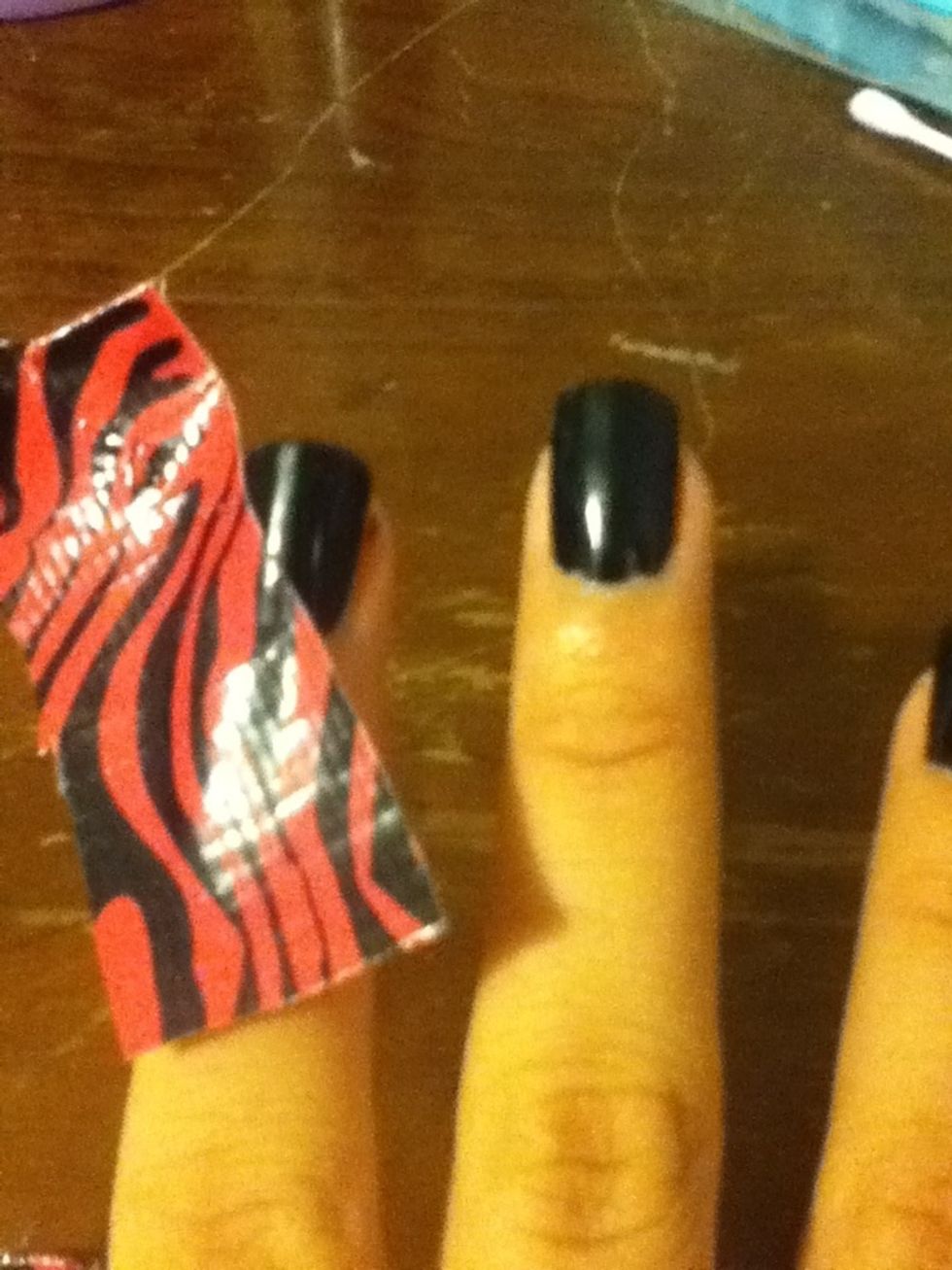 Put the tape on your nail diagonally starting at the tip of the left side of the nail and ending at the right cuticle.