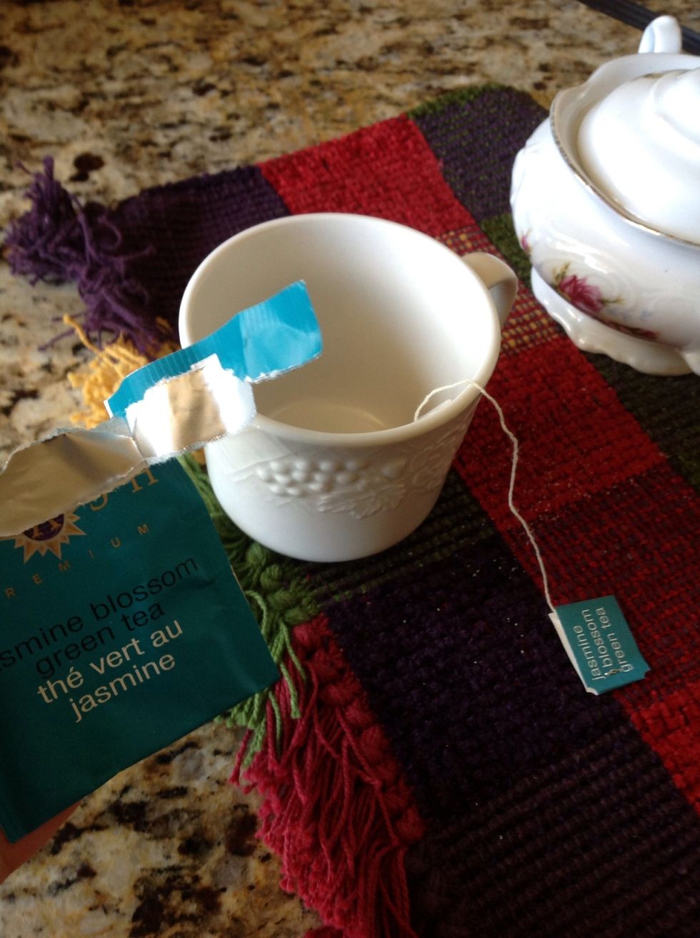 Put the tea bag into the mug.