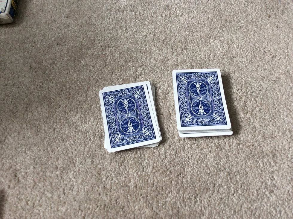 Put the third pile on the second pile, then pick that pile up.