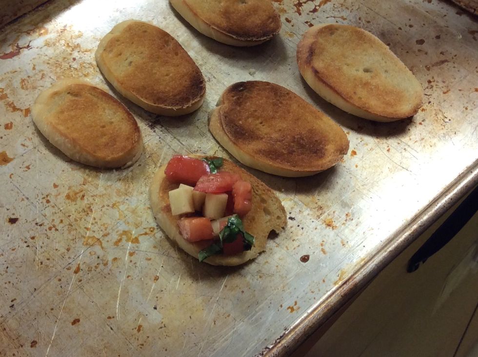 Put the tomato topping on the broiled bread slice. Use all of the filling, you might have to pile it nice and high.