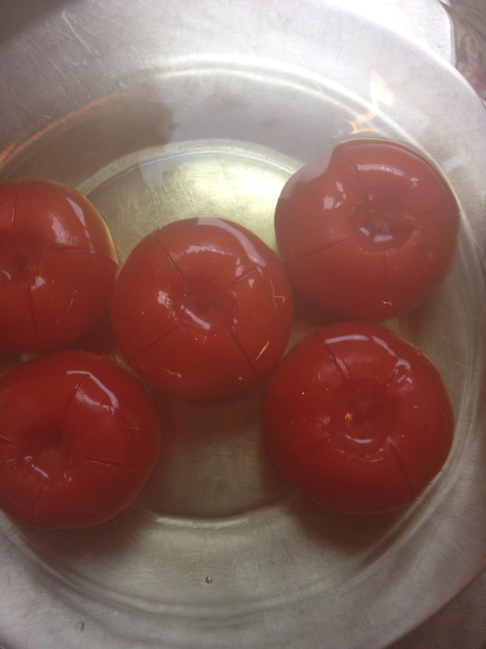 Put the tomatoes in a boiling water. 30 seconds.  Normally the very thin transparent skin should come out