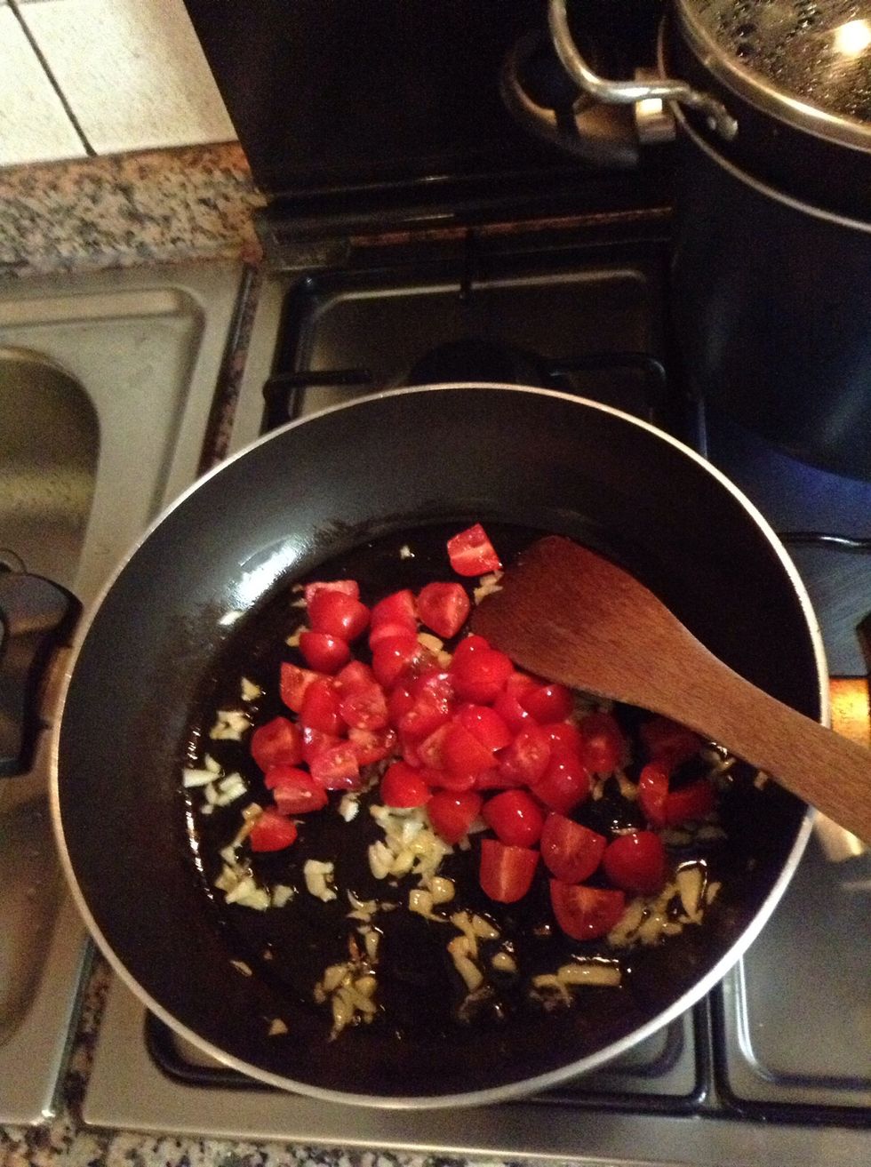 Put the tomatoes into the pan, cook them for a couple of minutes over medium heat.