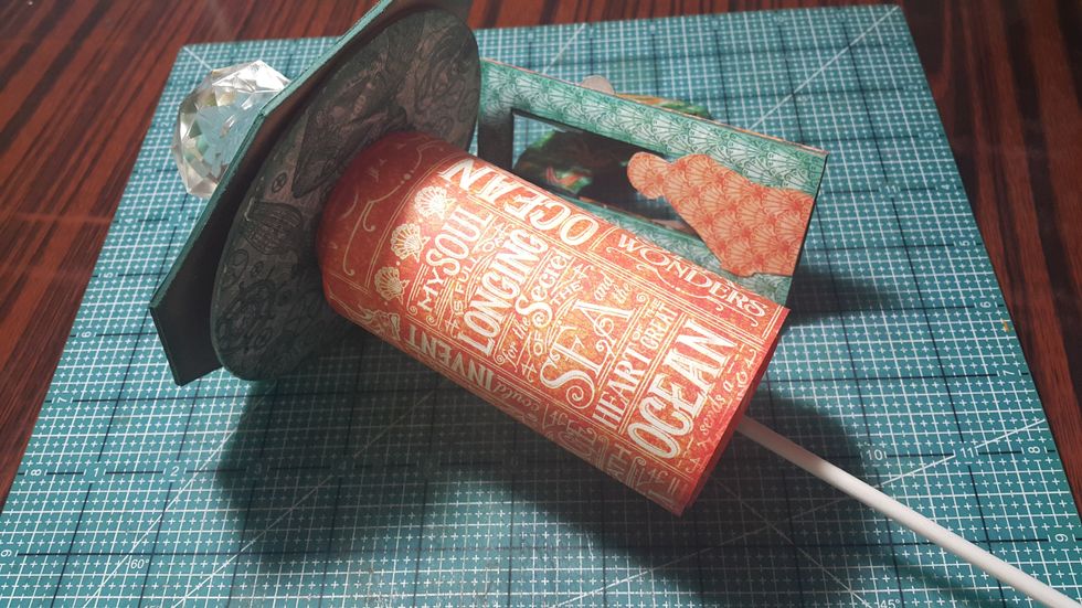 Put the top through the scroll album.