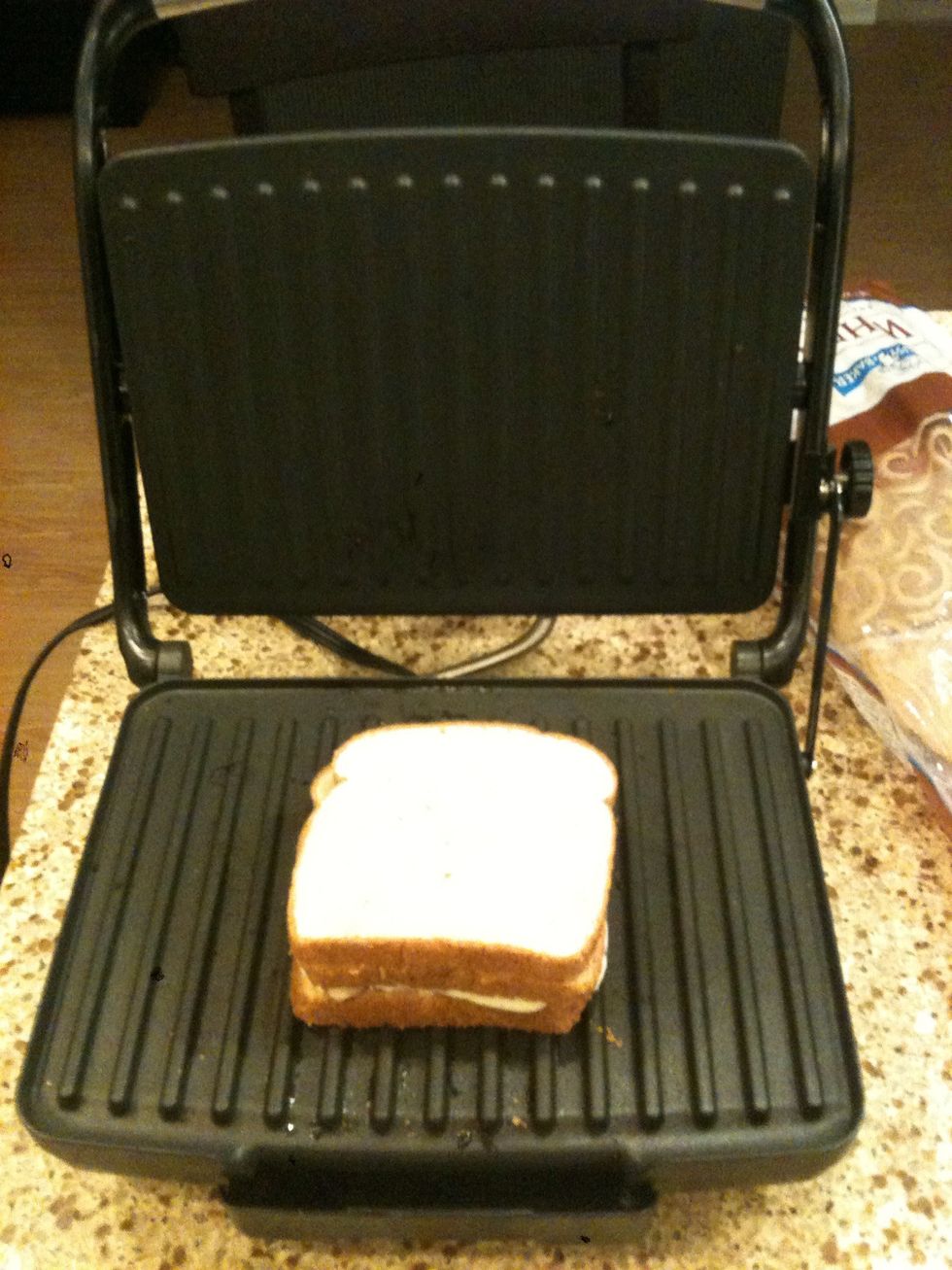Put the two halves together on your preheated panini press and close the lid