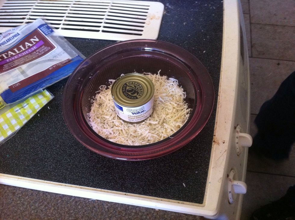 Put the unopened can of chopped black olives in the center of the cheese and \u27a1