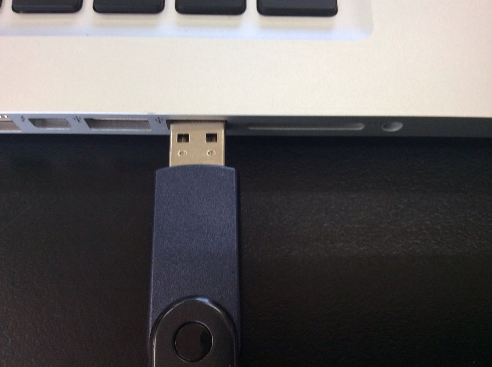 Put the USB stick in the the hole on the side of the Laptop