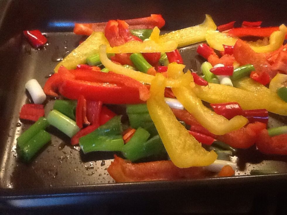 Put the veggies in a large baking tray, as well as 50ml of olive oil.