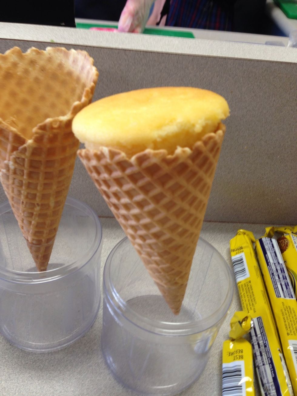 Put the waffle cone in a plastic container and cupcake in the top of the waffle cones