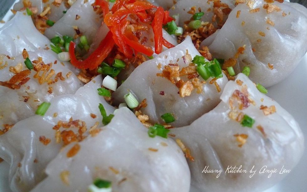 Put the warm vegetable dumplings on a serving plate, garnish with some fried garlic or shallot, red chillies and chopped green onions before serving.
