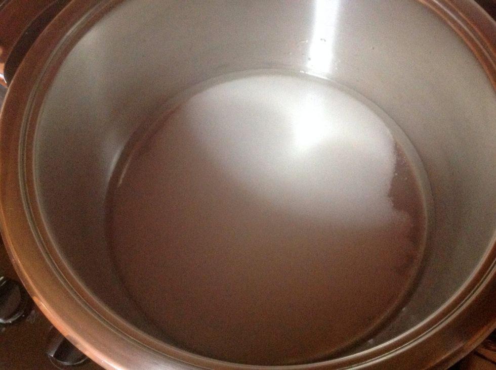 Put the water in a saucepan and add the sugar. Remove from heat when it reaches boiling point.