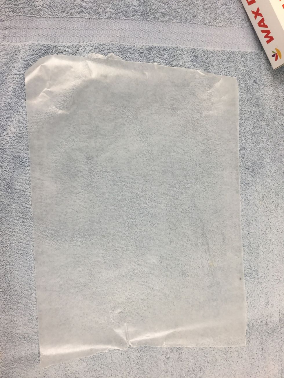 Put the wax paper on top of the towel