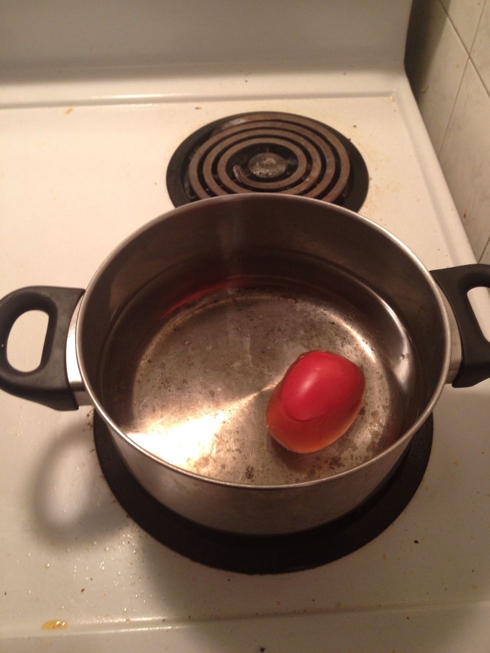 Put the whole washed tomato into hot water so it will be easier to take off the skin..