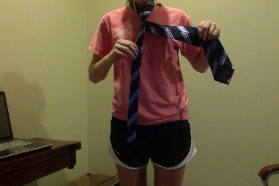 Put the wide end back behind the narrow end ending on the right side.