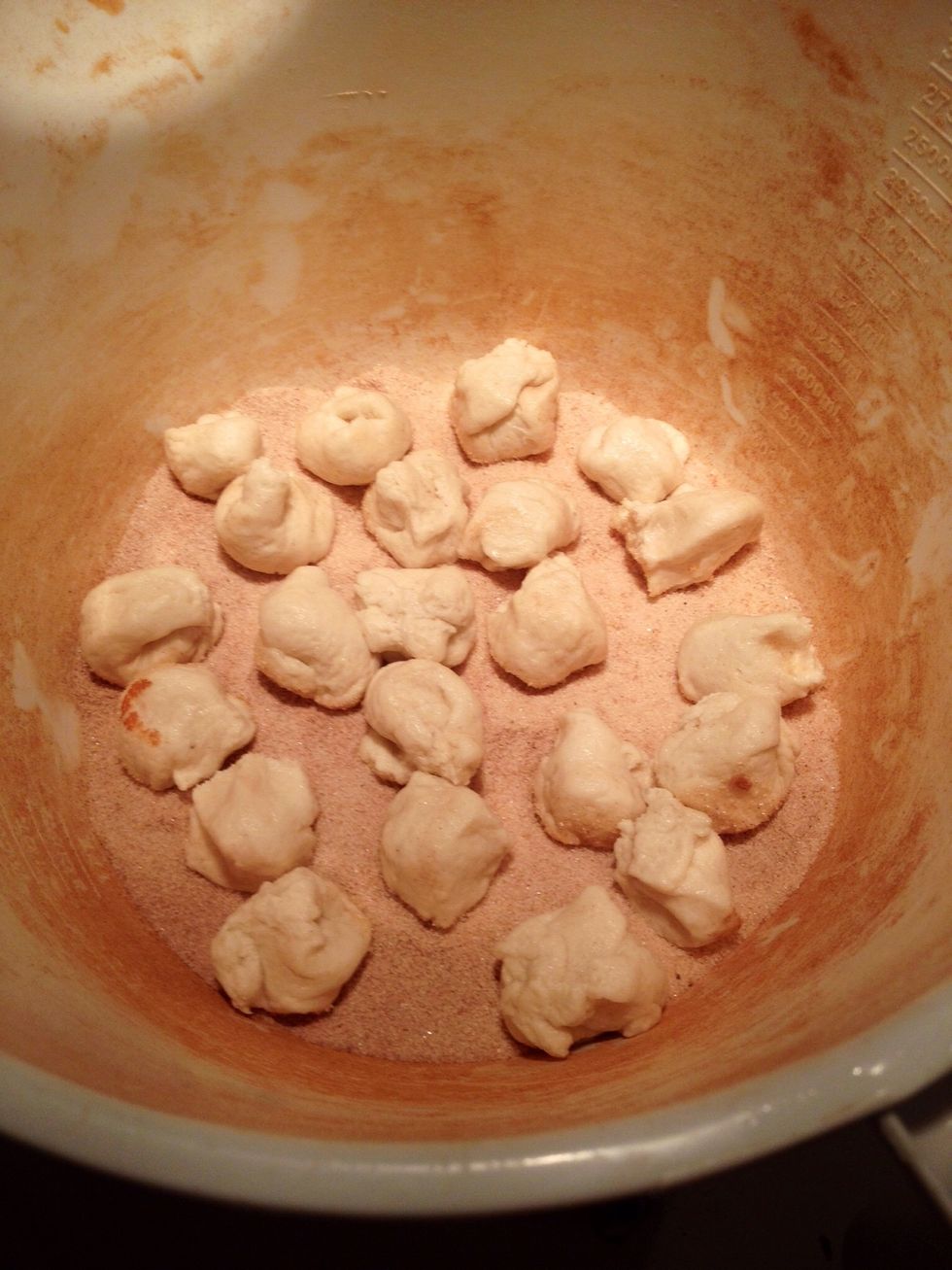 Put them in the cinnamon sugar and toss them around until completely covered