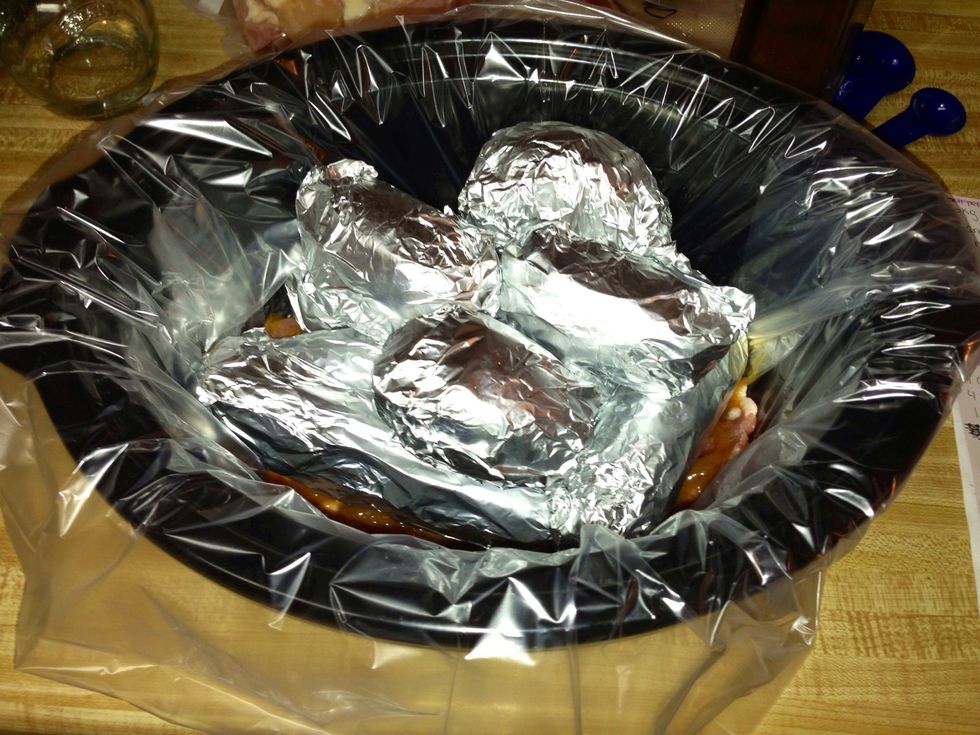 Put them on top of the meat. Yes On top of the sauce. It won't matter. You will have baked potatoes corn and pork chops just like they were cooked separately. Cook on hi for about 3-4 h or lo 5-6 Done