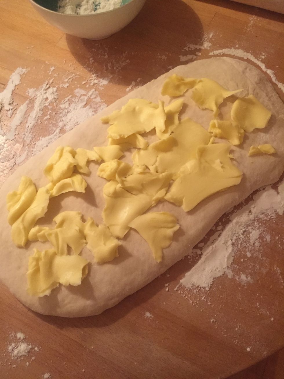 Put thin slivers of cold butter onto the rolled out dough.