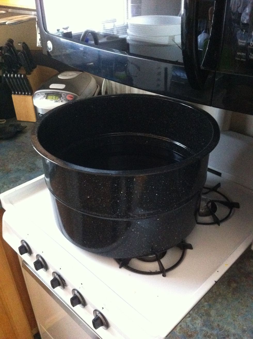put three gallons of cold water into a large cooking pot.