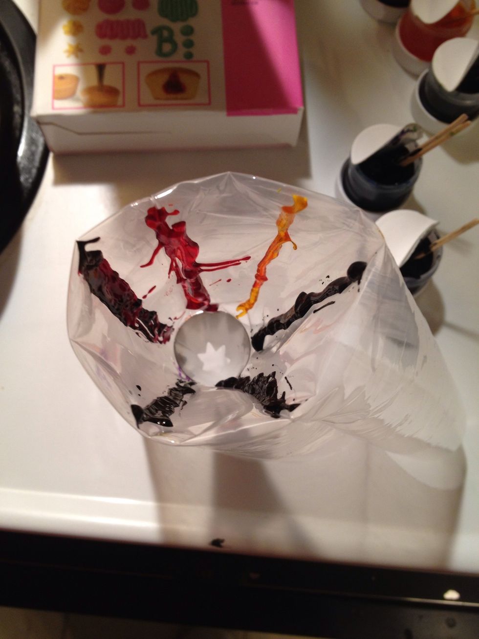 Put tip in decorating bag and fold down sides. Using toothpicks dipped in icing colors line the bag with the colors.