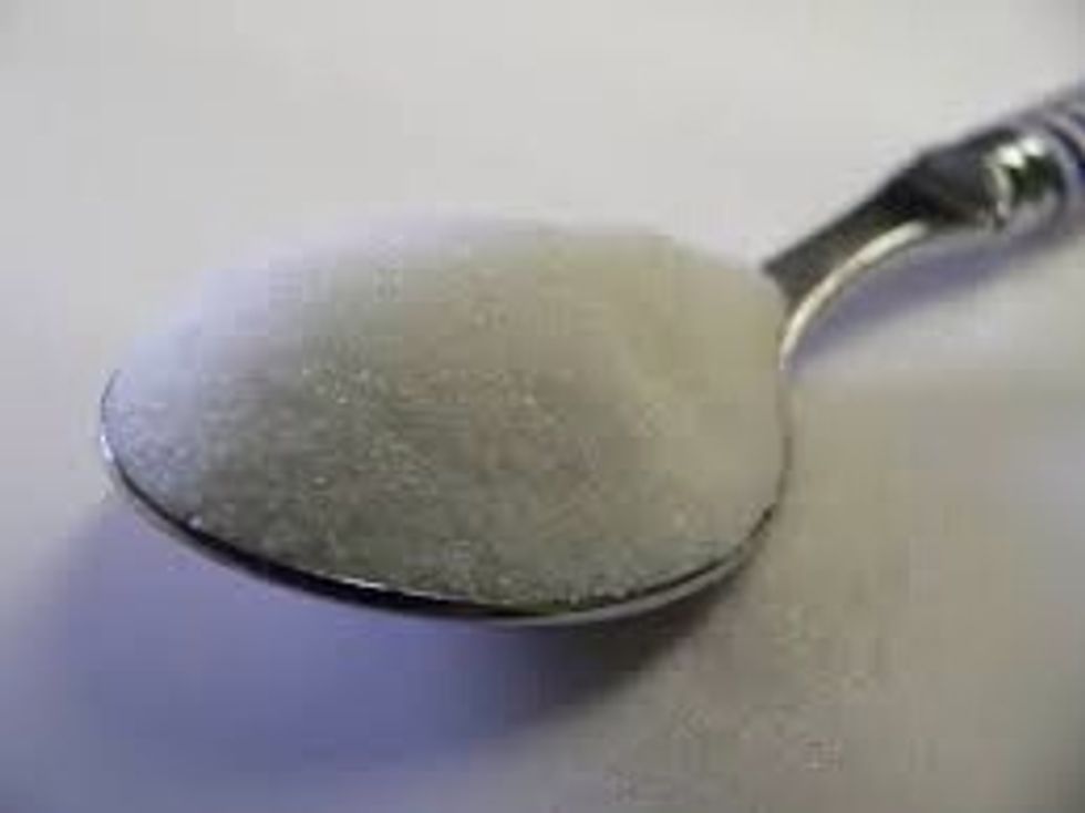 Put to teaspoon of sugar in the cup.