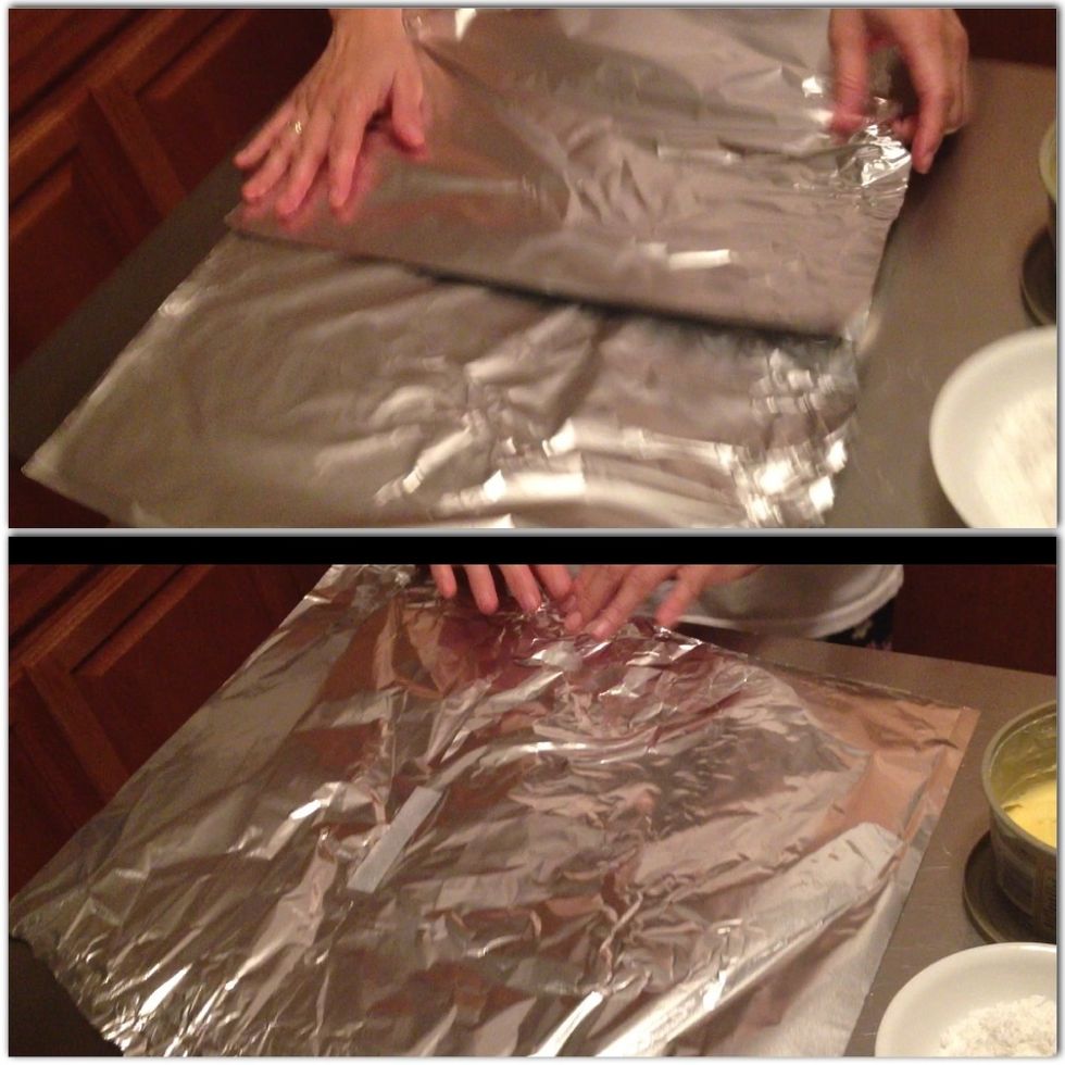 Put together enough aluminum foil to cover 2nd cookie sheet or baking pan and then grease with butter or cooking spray. (Taped side should be the back part of foil & not touch the food)
