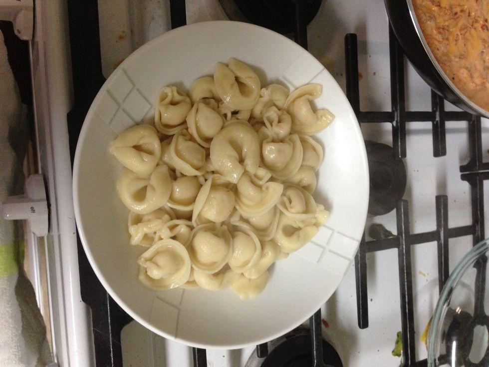 Put tortellini in bowl