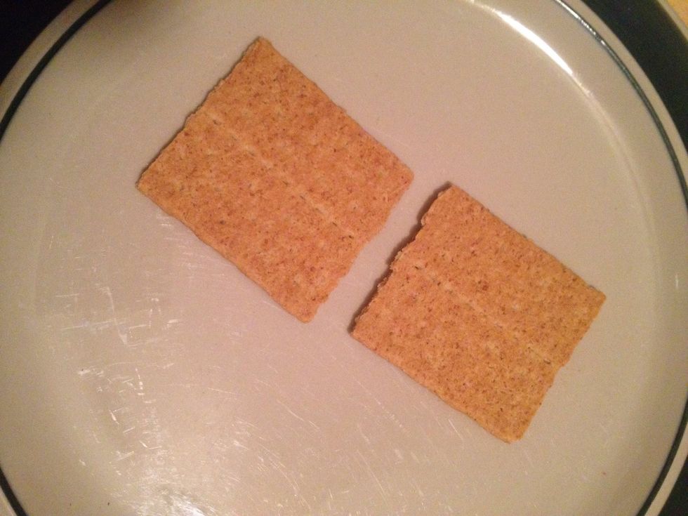 Put two square graham crackers on a plate.