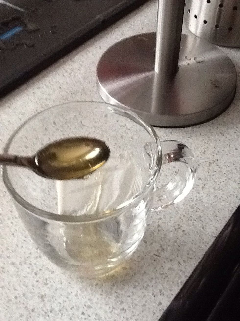 Put two teaspoons of honey into the mug.