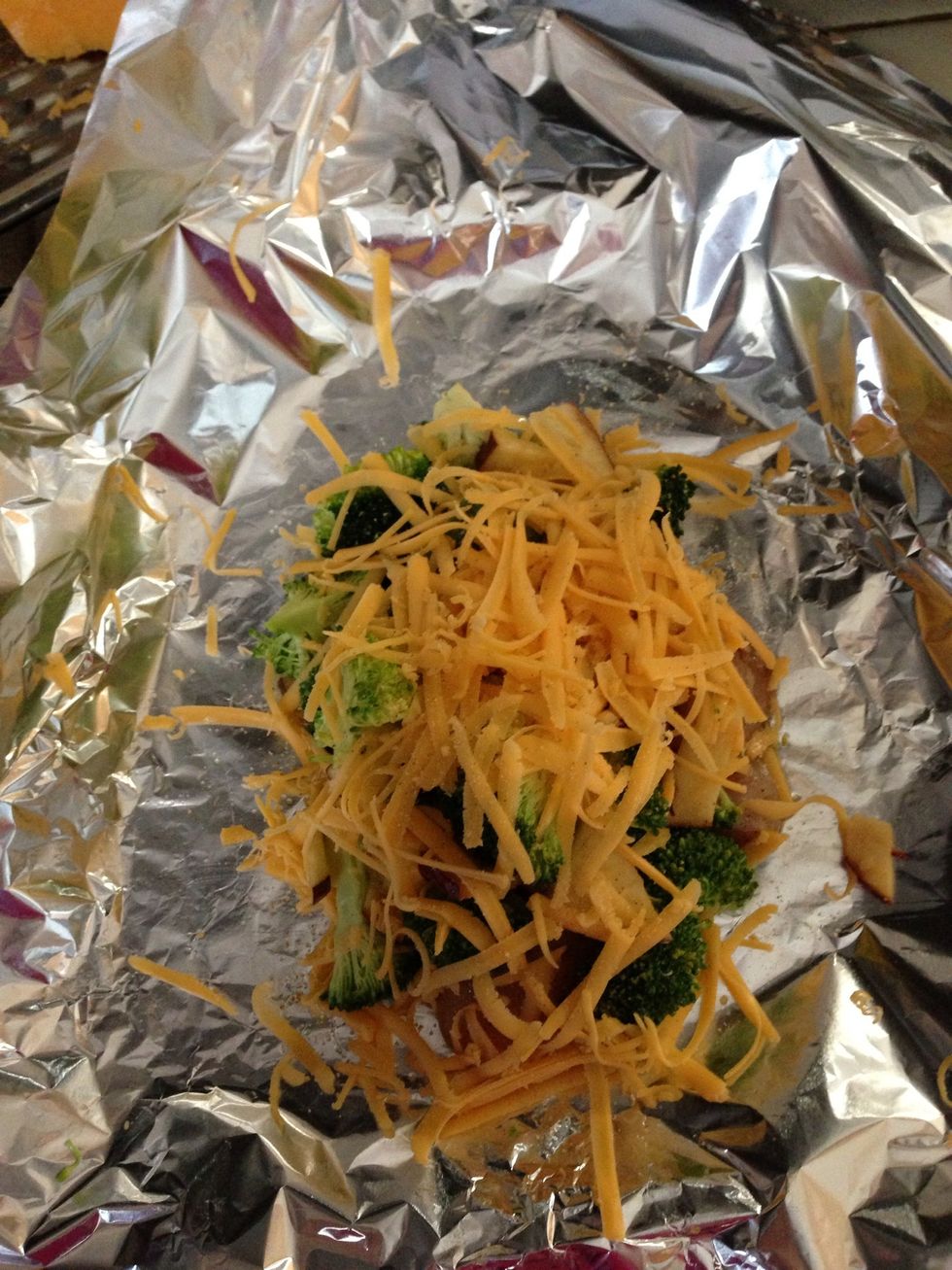 Put veggie mix Over chicken breast. Add cheddar cheese on top. Completely covered chicken and veggies with tinfoil.