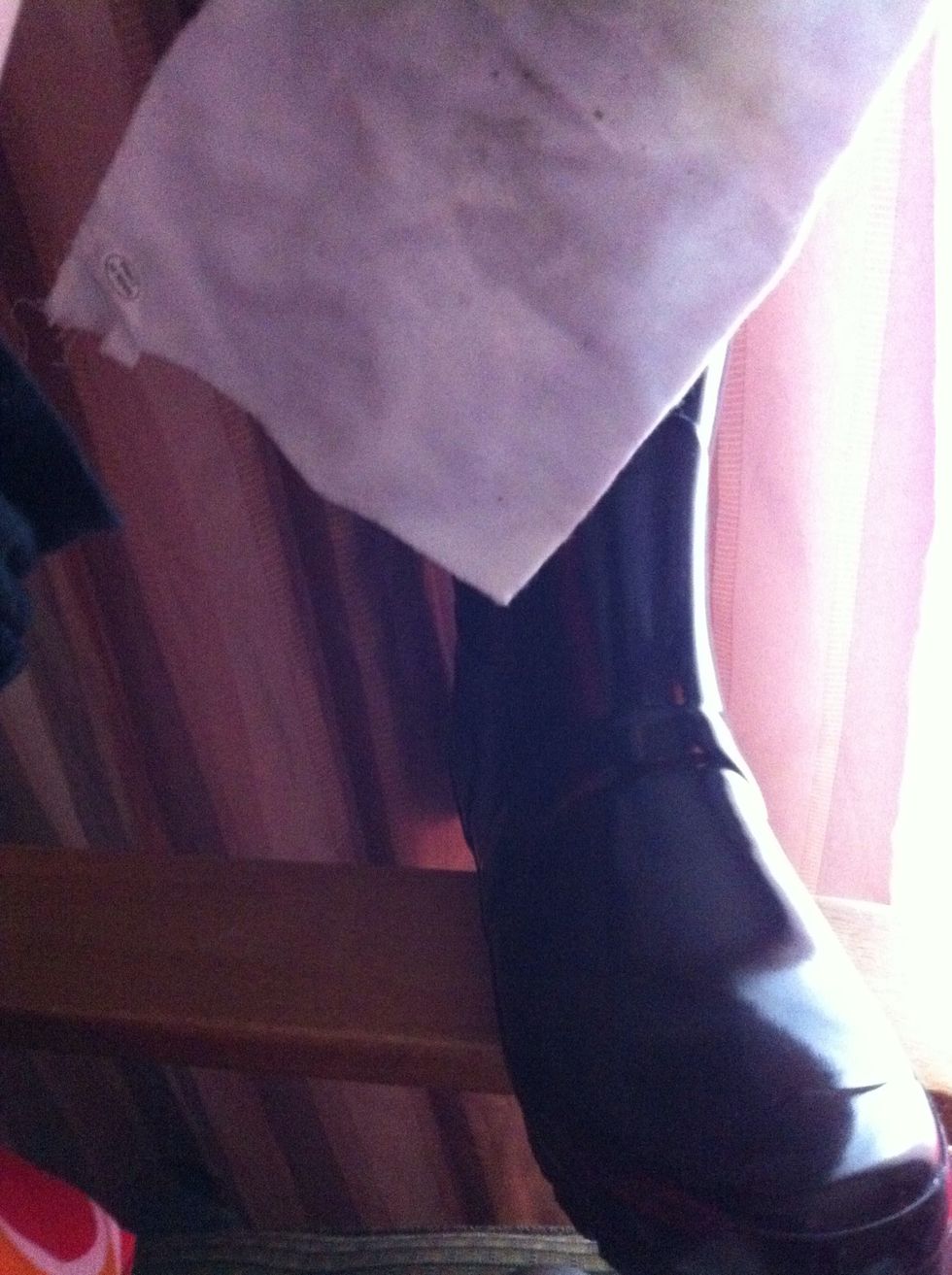 Put warm sink water on a white cloth and clean off the dirt from the boots Then let it dry off