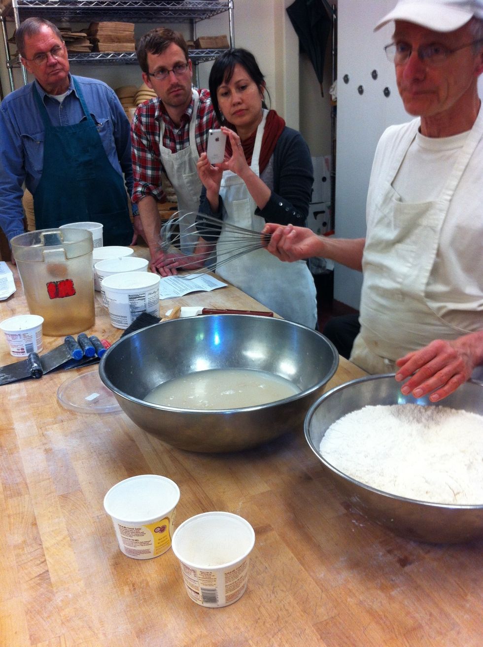 Put water in a bowl, add yeast and whisk.