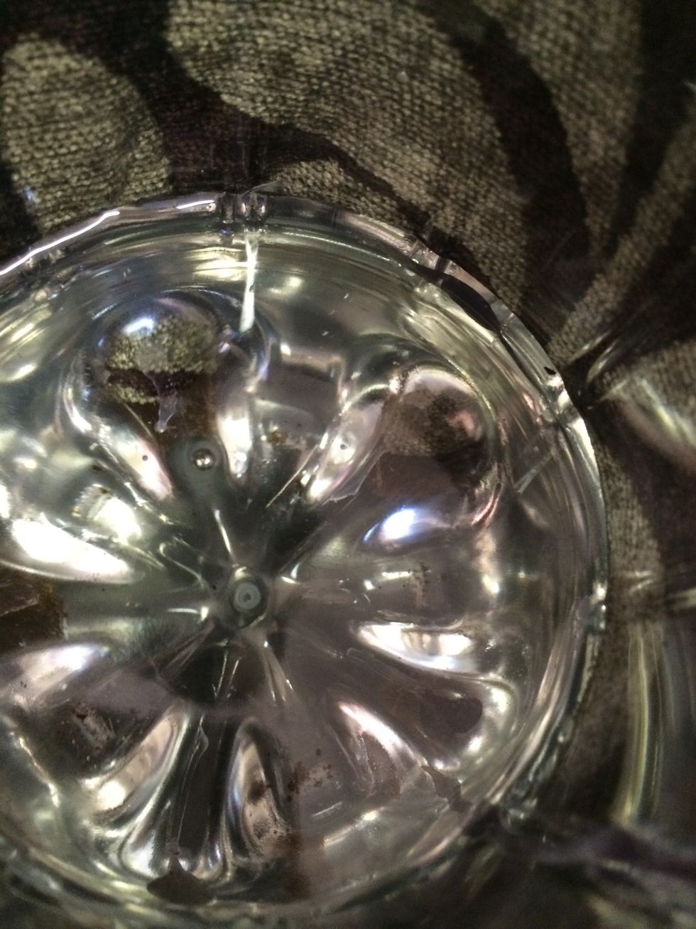 Put water in the base of the bottle and sit the top in, larger opening to the top.