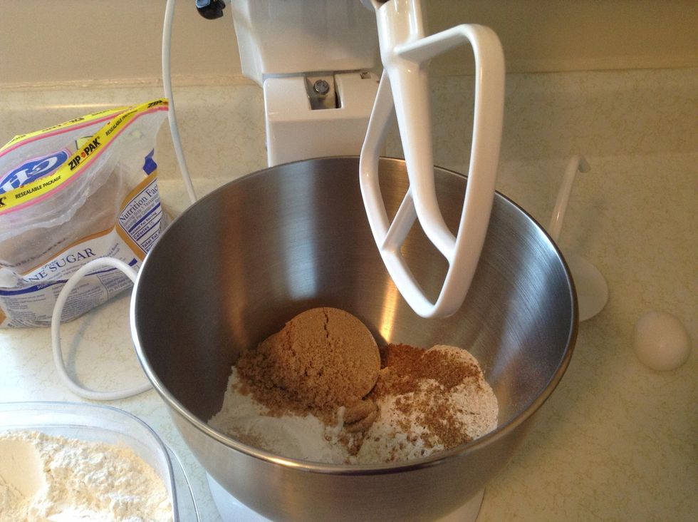 Put wheat flour, brown sugar, yeast, salt, flaxseed, and 1 cup of the white flour in large mixing bowl. I use my Kitchen Aid mixer, with the flat beater attached.