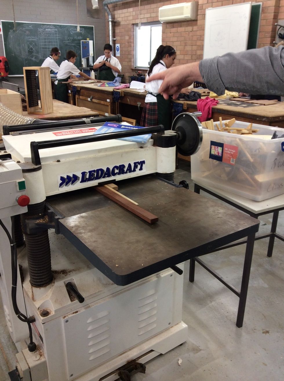 Put wood through the machine