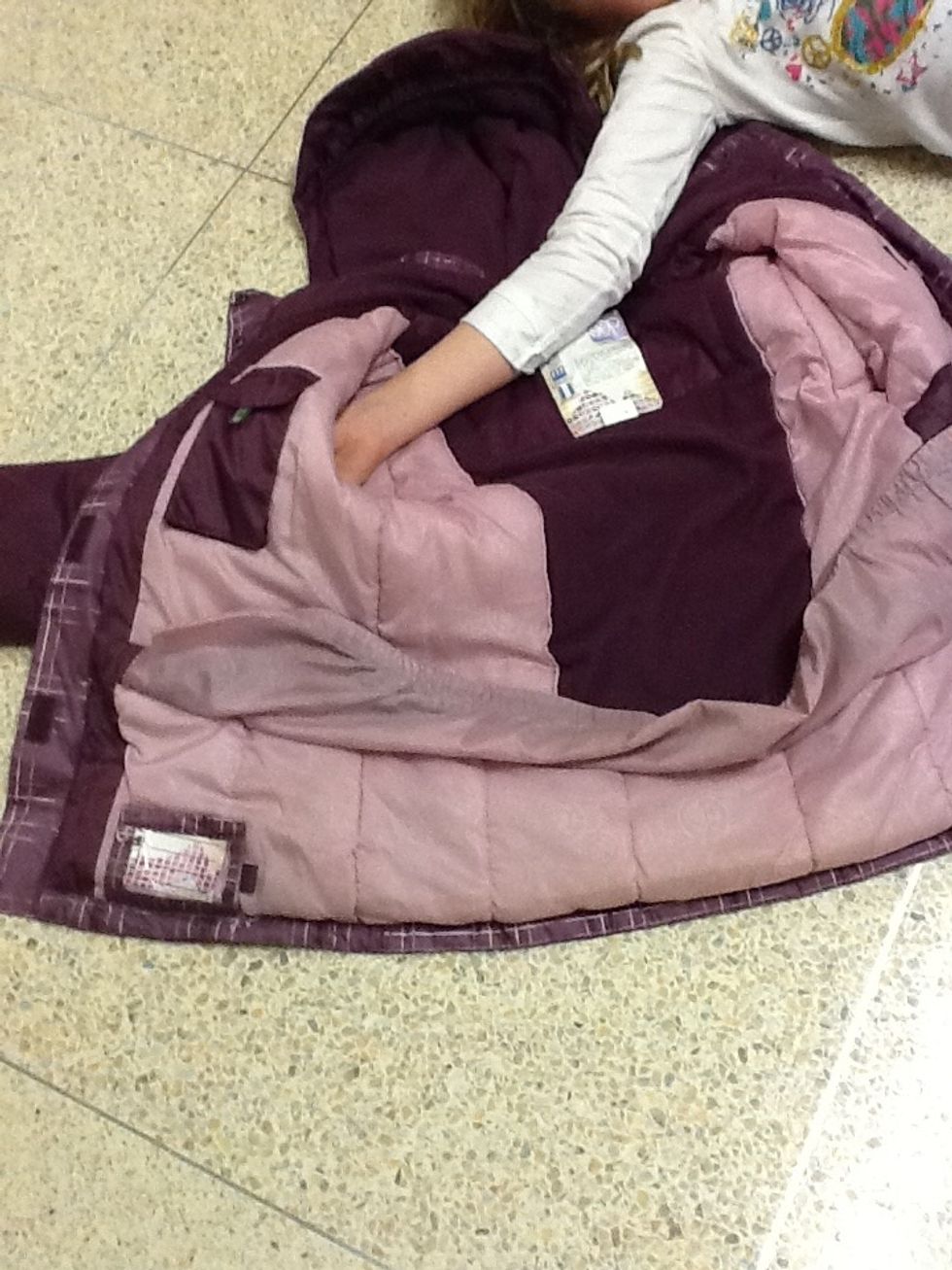 Put you arm though the arm hole in you coat.