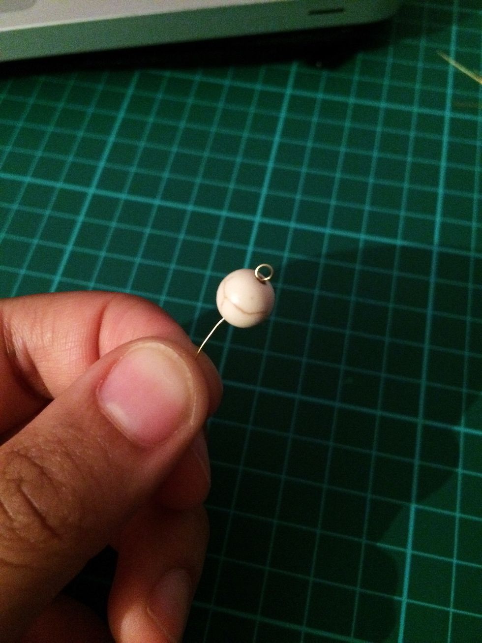 Put your bead through the wire and push it up so that you can't the see the wrapping, only the end loop.