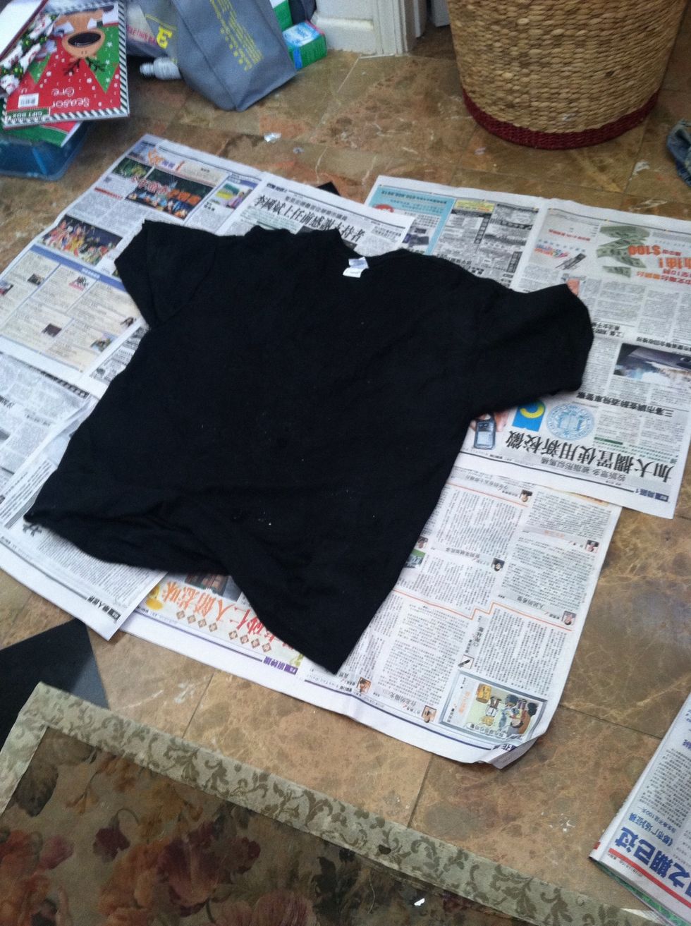Put your black shirt on newspaper.