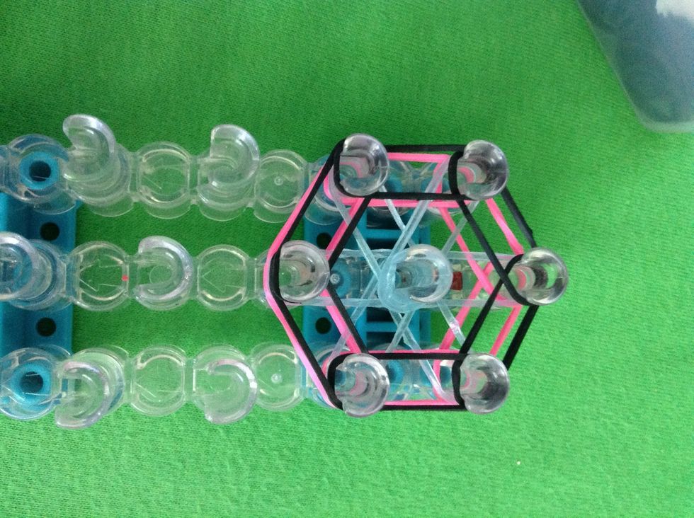 Put your cap band on the middle peg