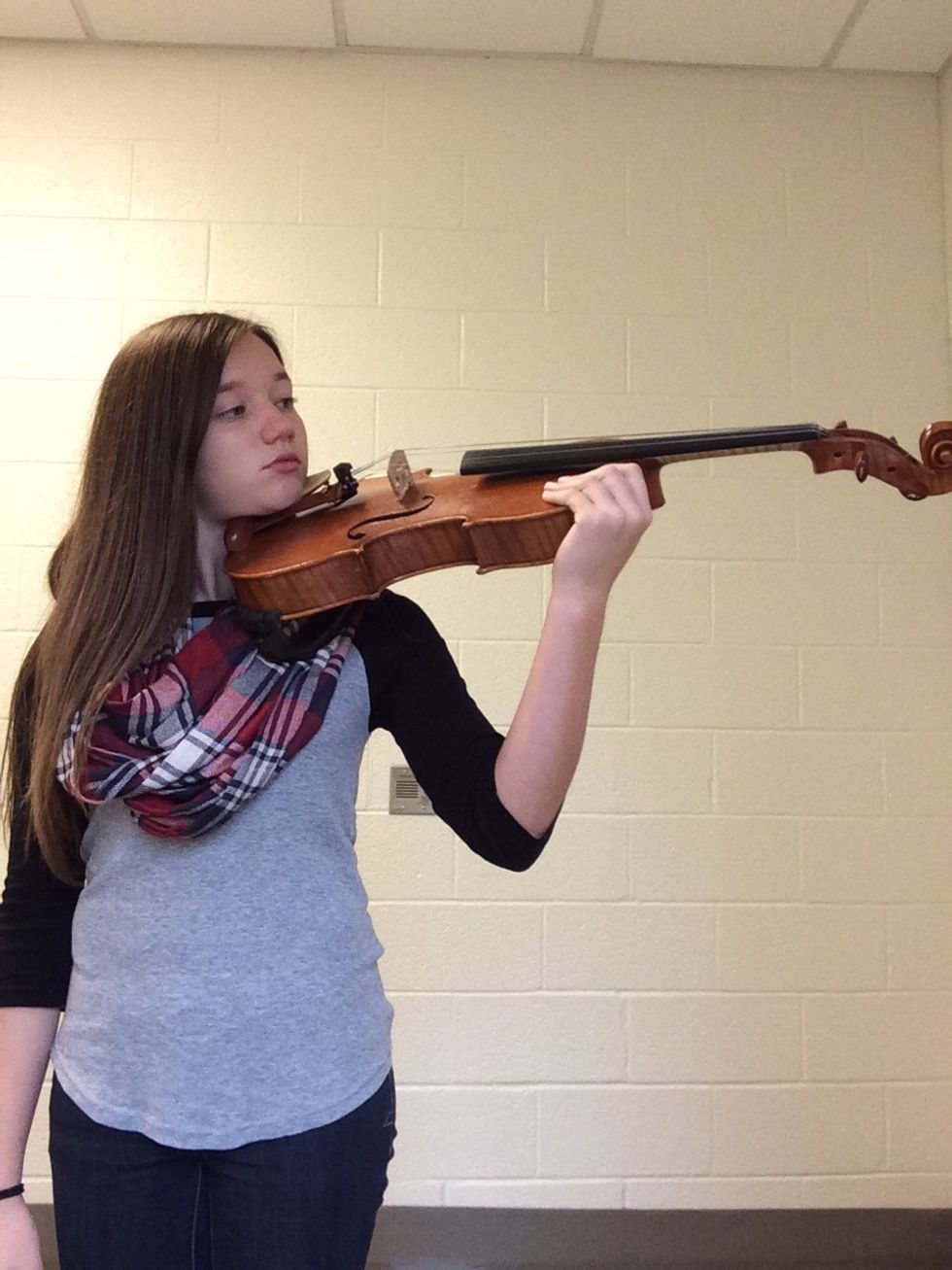 Put your chin on the chin rest and make sure the shoulder rest is feeling good. Make sure when to hold the instrument, you stand with good posture. And pick up the bow.