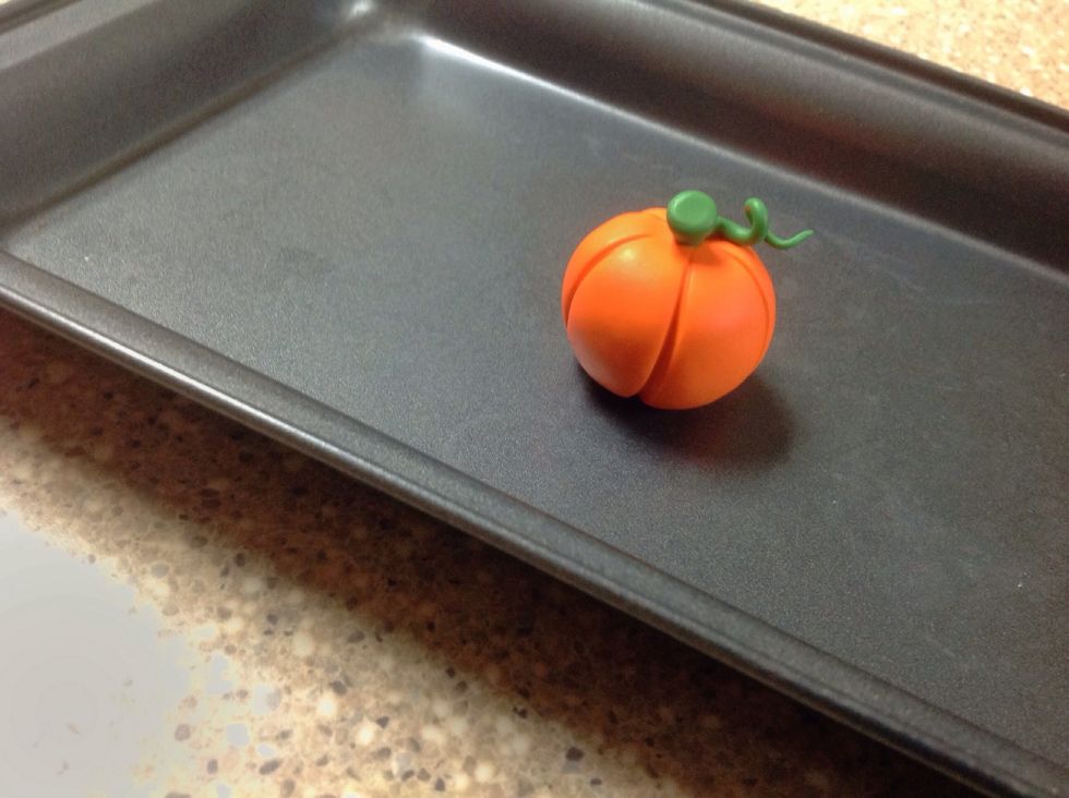 Put your completed pumpkin onto the cookie sheet and place it into the oven.