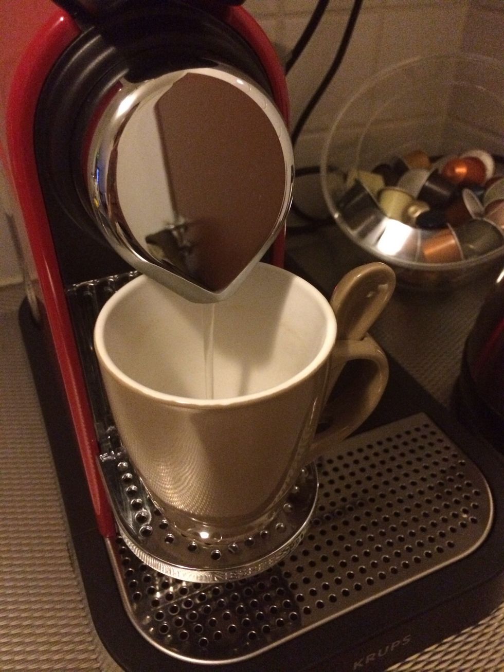 Put your cup in place and press the lungo button. Warm water will start running and that will warm up your cup.