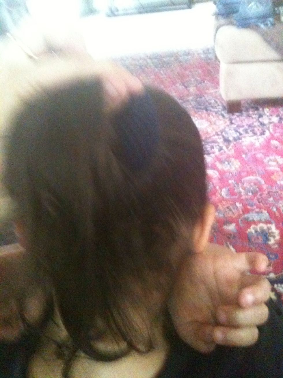 Put your doughnut ( sock) around the ponytail all the way at the base