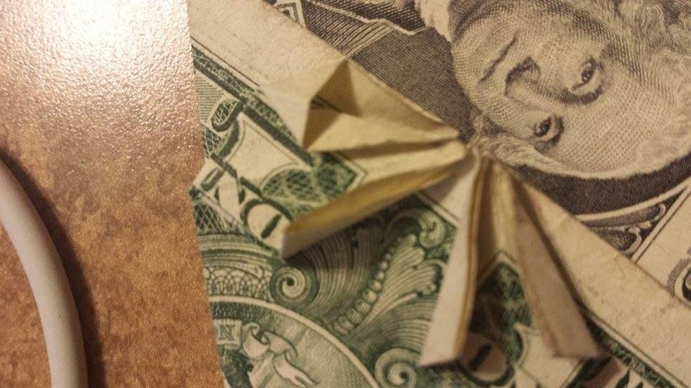 Put your finger on the top and push down, it should make a triangle on top.