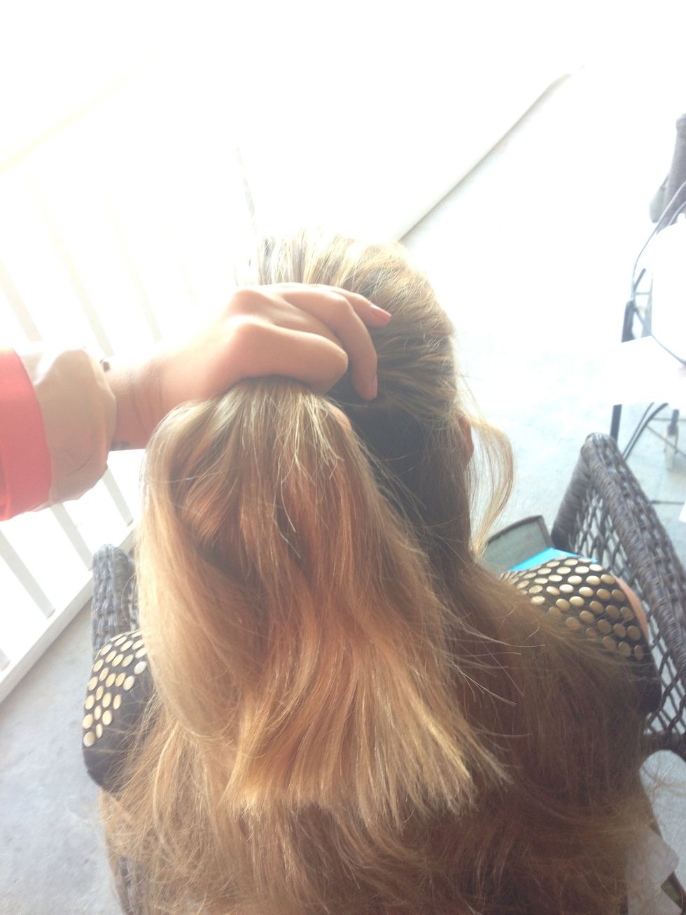 Put your hair up in a half pony tail (you may damp your hair a little here so it's easier and you don't get as many fly aways but it's up to you)