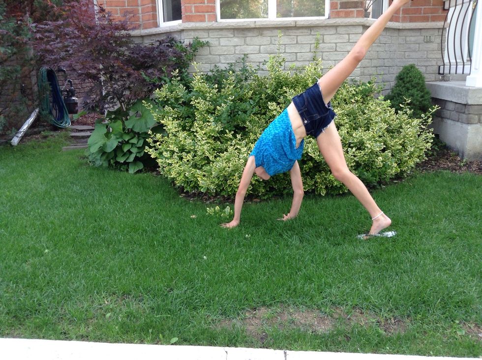 Put your hands on the ground and kick your foot up